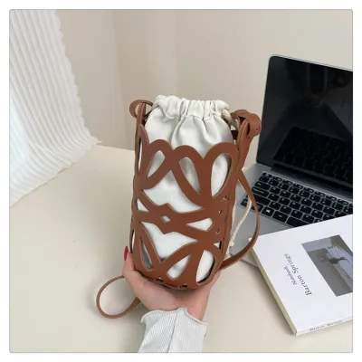 Women Fashion Casual Personalized Design Solid Color Hollow Cylinder PU Leather Belt Crossbody Bucket Bag