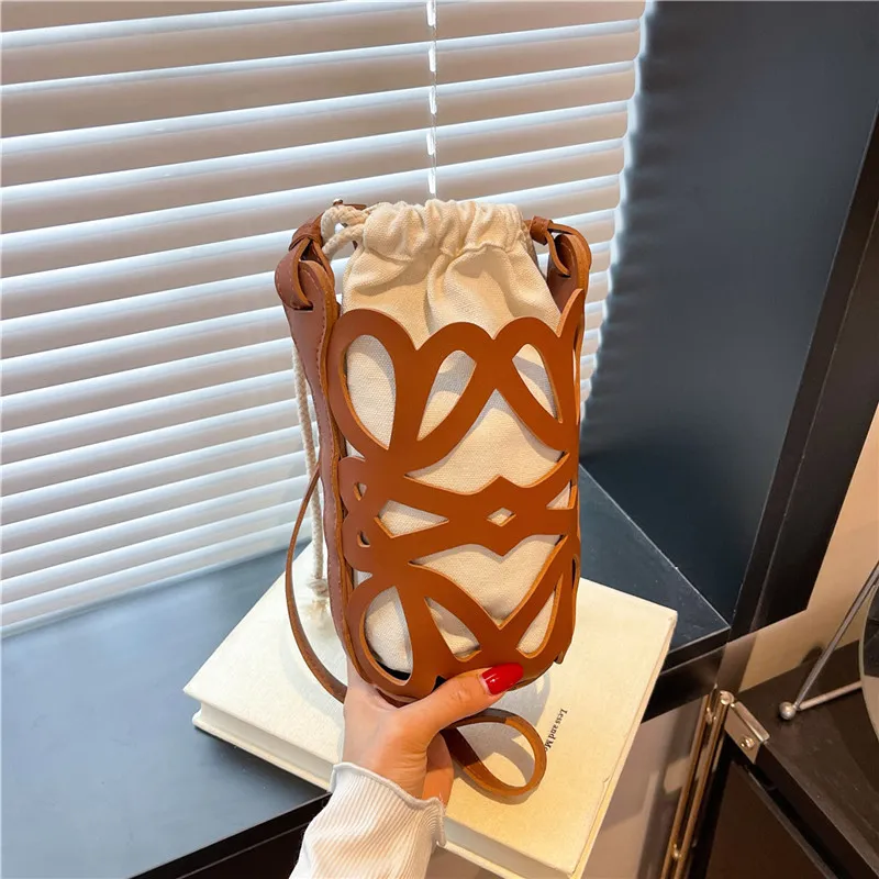 Women Fashion Casual Personalized Design Solid Color Hollow Cylinder PU Leather Belt Crossbody Bucket Bag